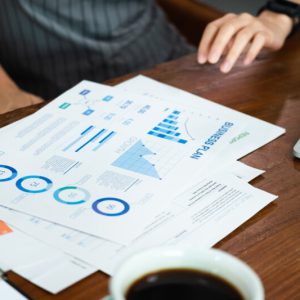 close up asian barista business owner show business plan to financial advisor about loan contract for open new restaurant business.small business entrepreneur